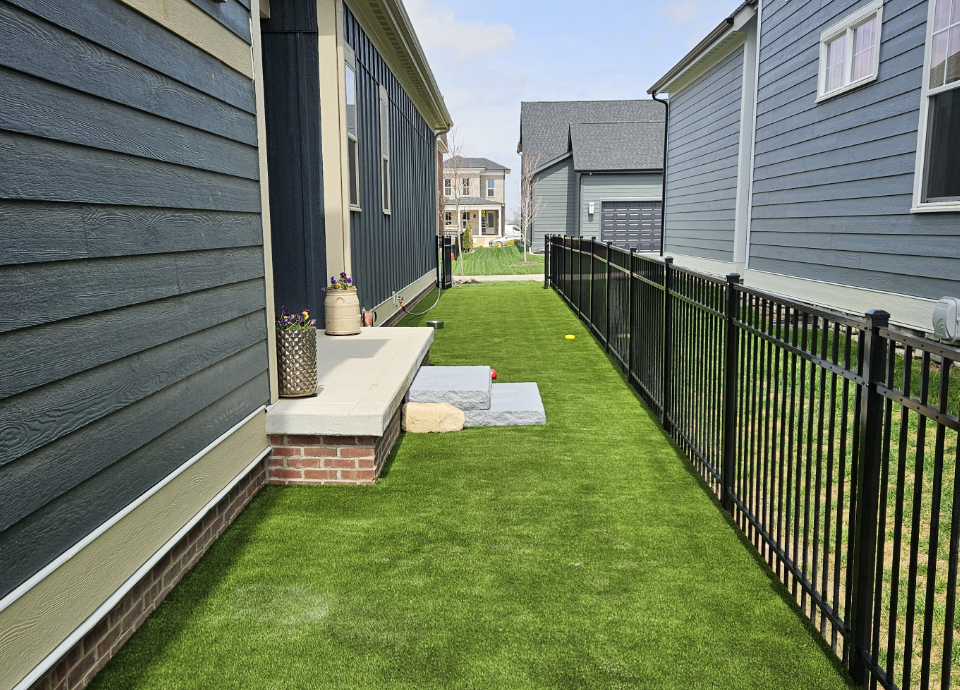 artificial grass side yard and dog run next to ohio home